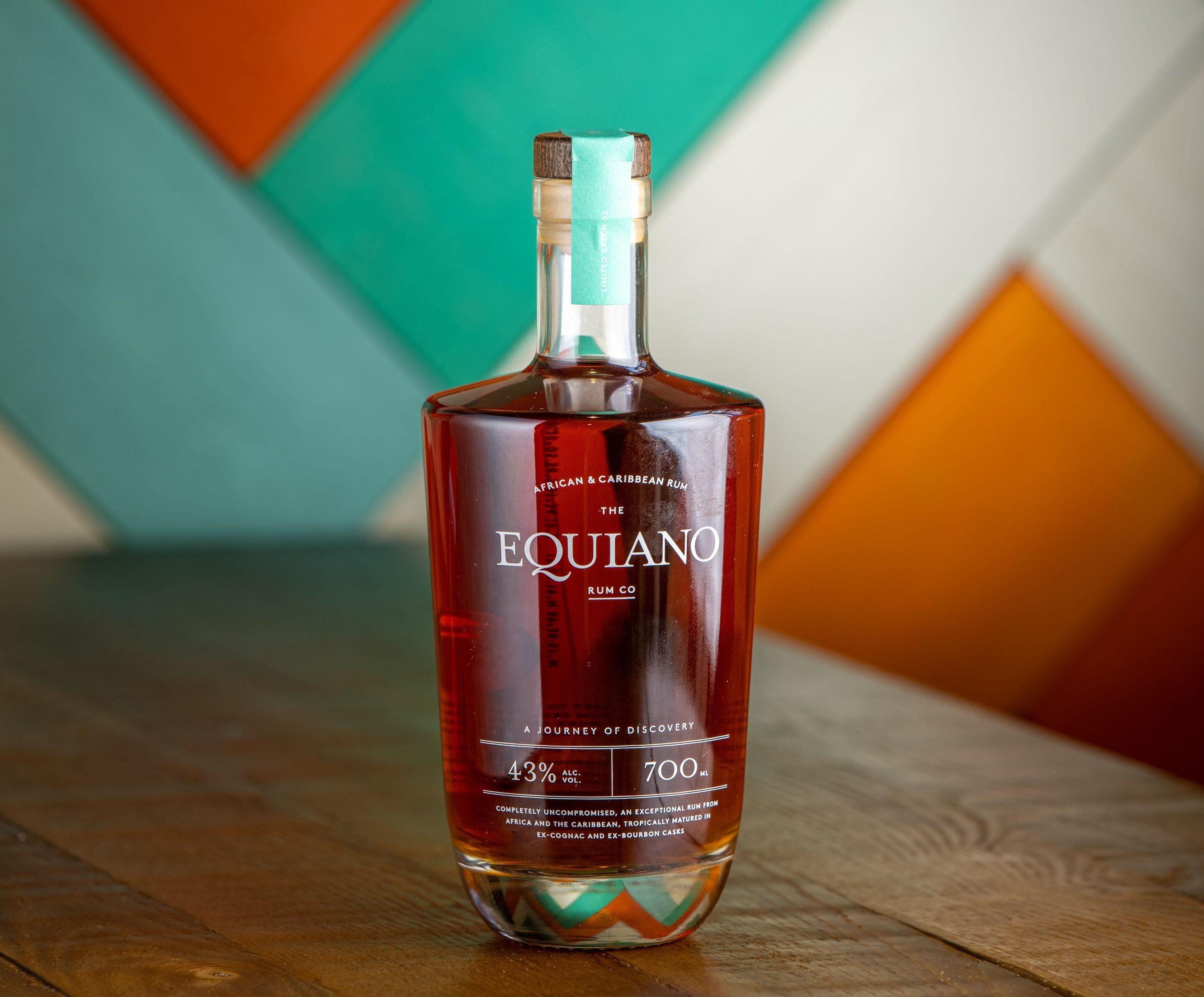 Bottle of Equiano Rum with colourful wooden background