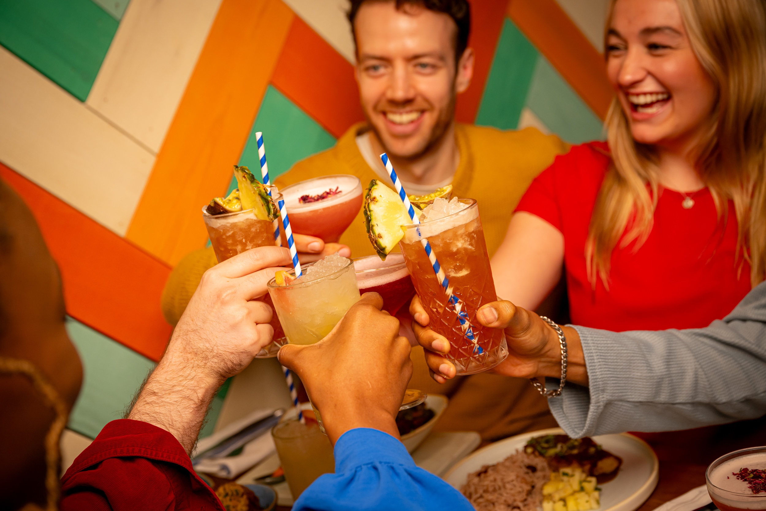 Group cheersing cocktails