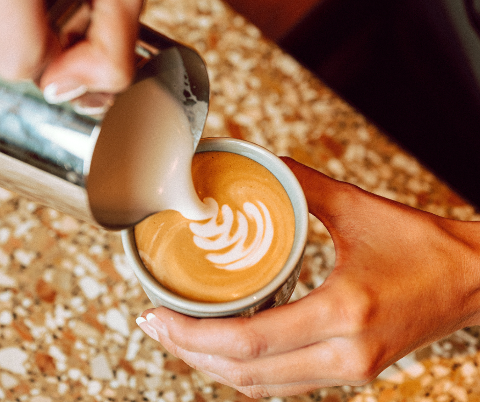 Flat white being poured with latte art