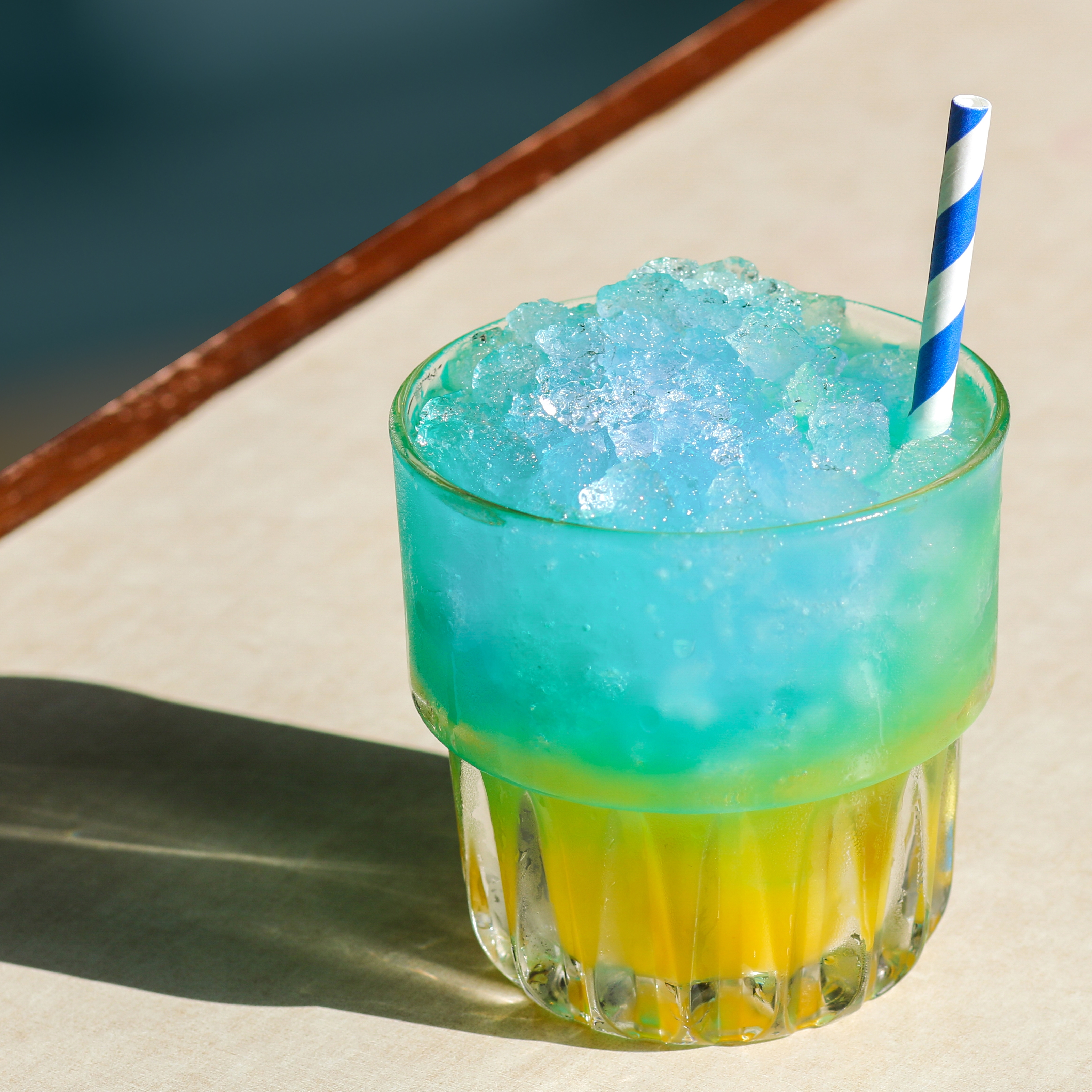 Blue Bay cocktail for Ukraine on sunny table
