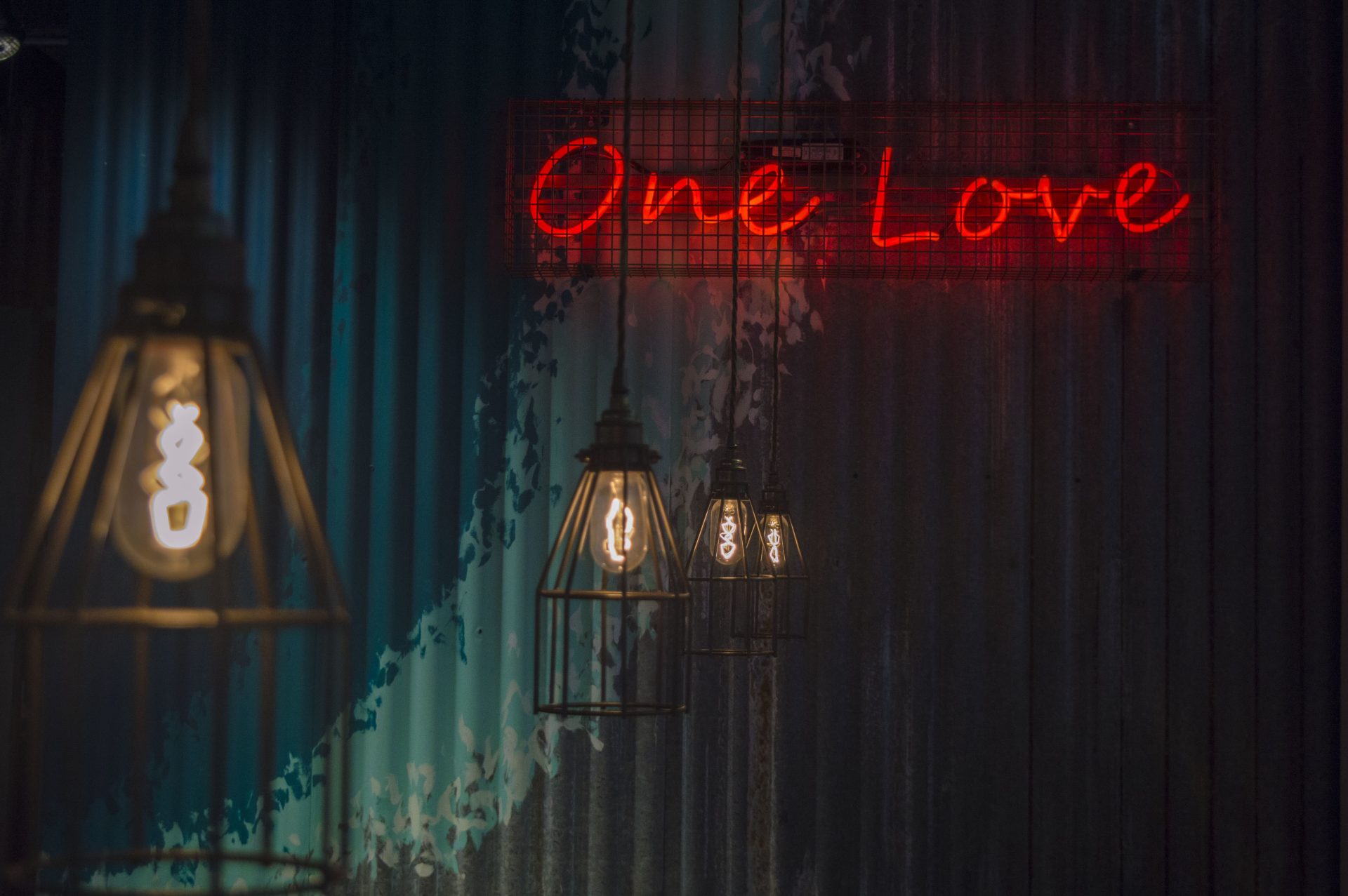 One Love neon sign and hanging lights interior decor