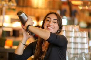 Smiling bartender with Cocktail Shaker