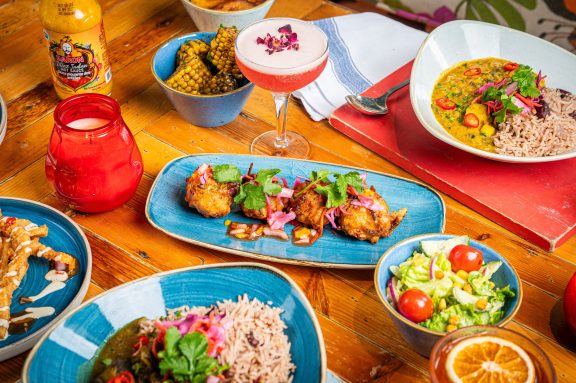 Sweetcorn fritters on a table with cocktail